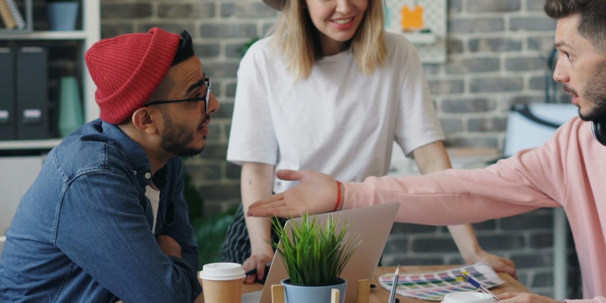 A team actively discussing and strategizing in a modern office environment, reflecting problem-solving and collaboration.