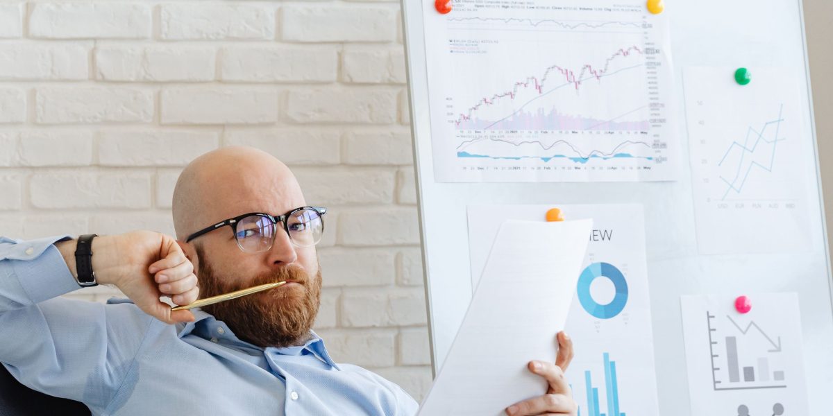 A business owner reviewing a growth chart, symbolizing the strong return on investment from effective digital marketing strategies like email automation.