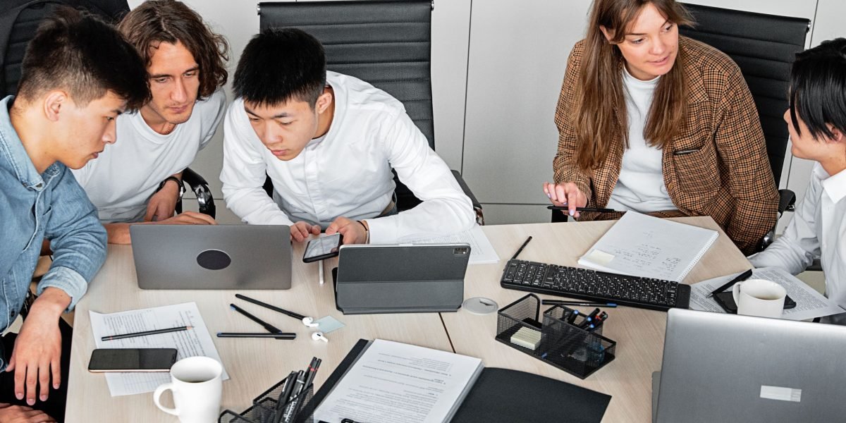 A team collaborating in a professional setting, discussing project goals and a design brief with clear objectives.