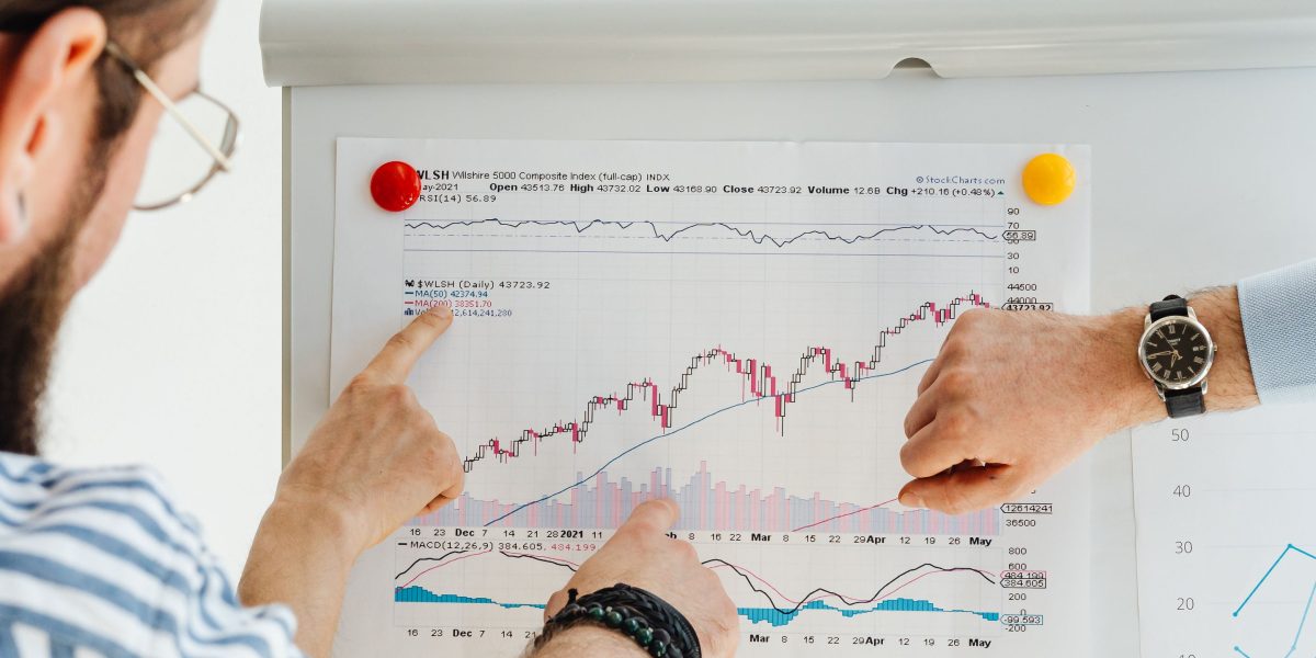 A marketing team collaborates, analyzing charts and data on a screen to understand campaign performance and identify areas for optimization.