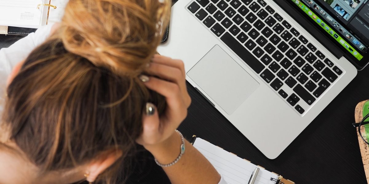 A person looking frustrated while interacting with a digital device, symbolizing a poor user experience.