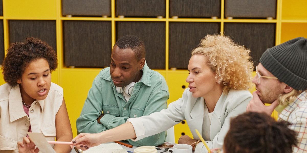 A team of professionals actively discussing and planning, symbolizing strategic decision-making for website improvement.
