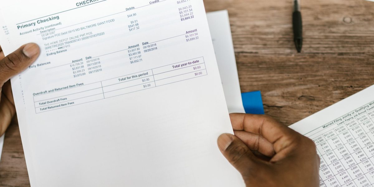 A business owner thoughtfully examining financial reports or analytics, representing the evaluation of investment returns.