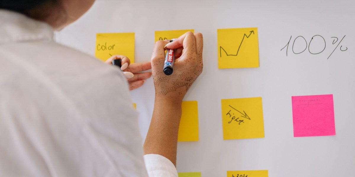 A person thoughtfully working to solve a complex business problem, symbolizing the strategic thinking needed for new ventures.