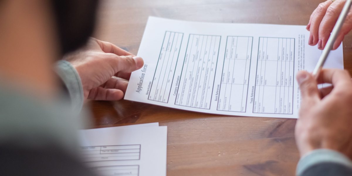 A business owner meticulously reviewing financial documents and proposals.