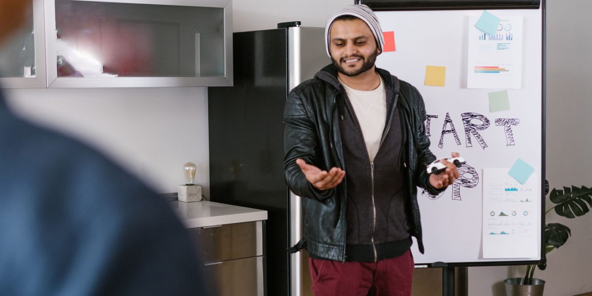 A professional explaining concepts on a whiteboard, representing the input phase of AI website creation.