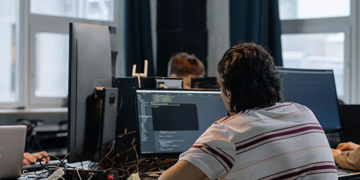 Professionals collaborating in a modern office, symbolizing the growing tech job market.