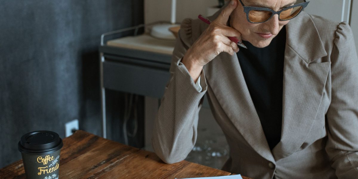 A business owner thoughtfully considering strategies for online growth and lead generation.