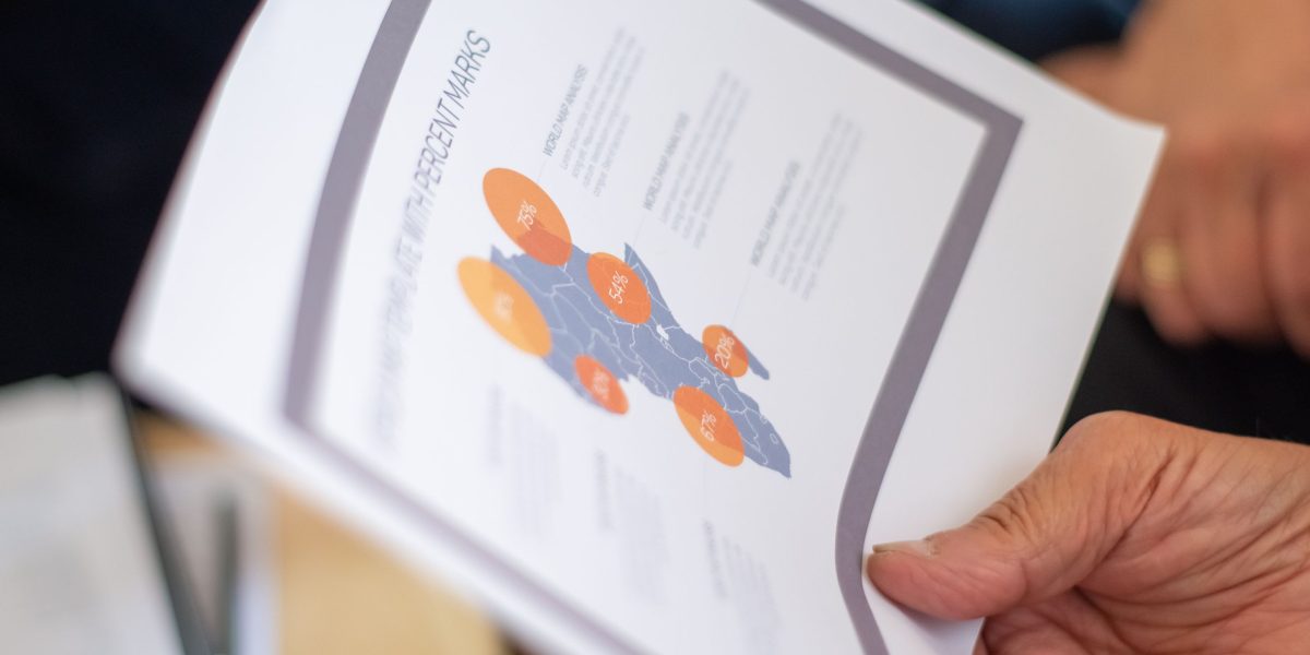 A team of professionals successfully reviewing progress reports, indicating positive outcomes.