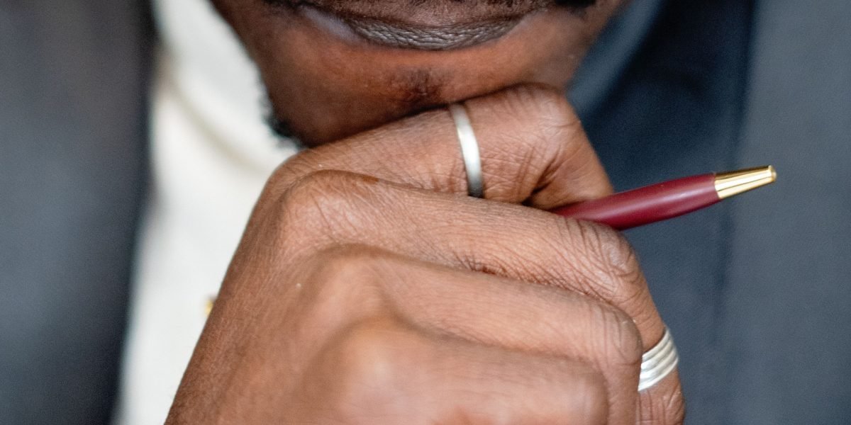 A business owner thoughtfully considering their options for a critical business decision.