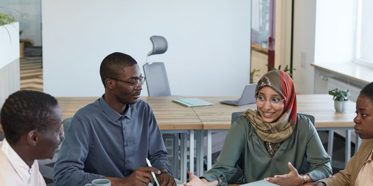 A diverse team collaborating actively in an office setting, focused on achieving business growth.