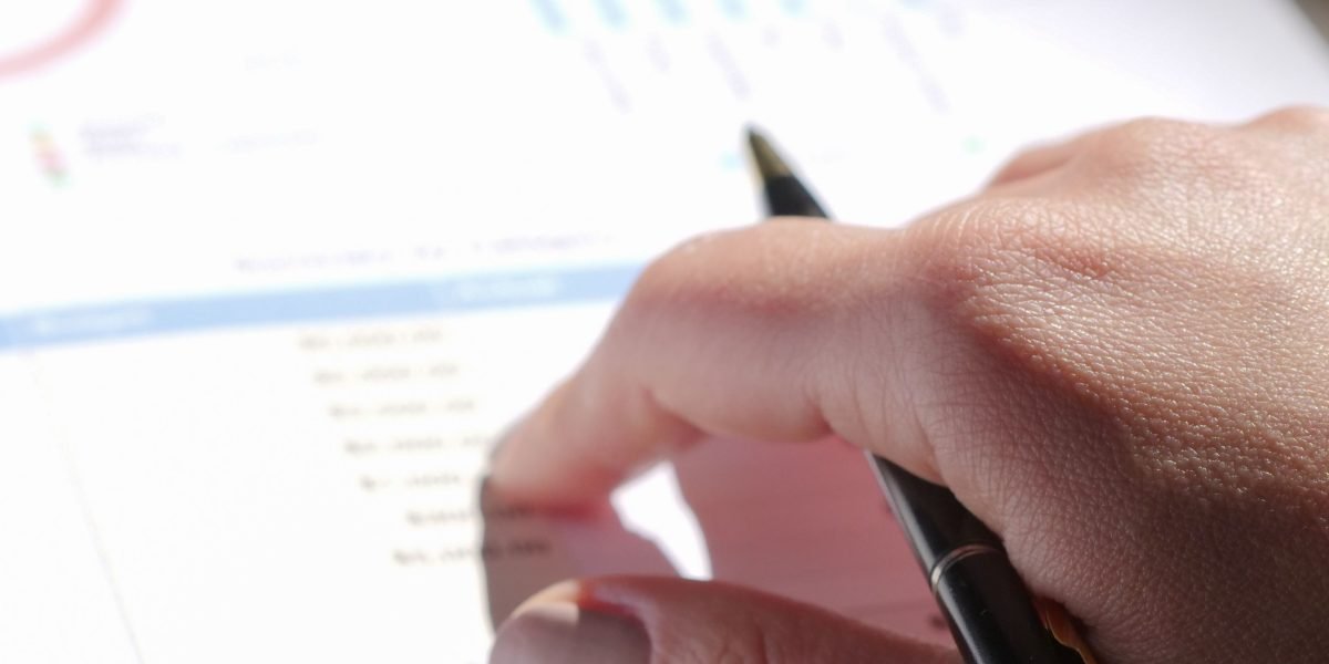 A professional meticulously reviewing performance reports or case studies in a modern office environment.