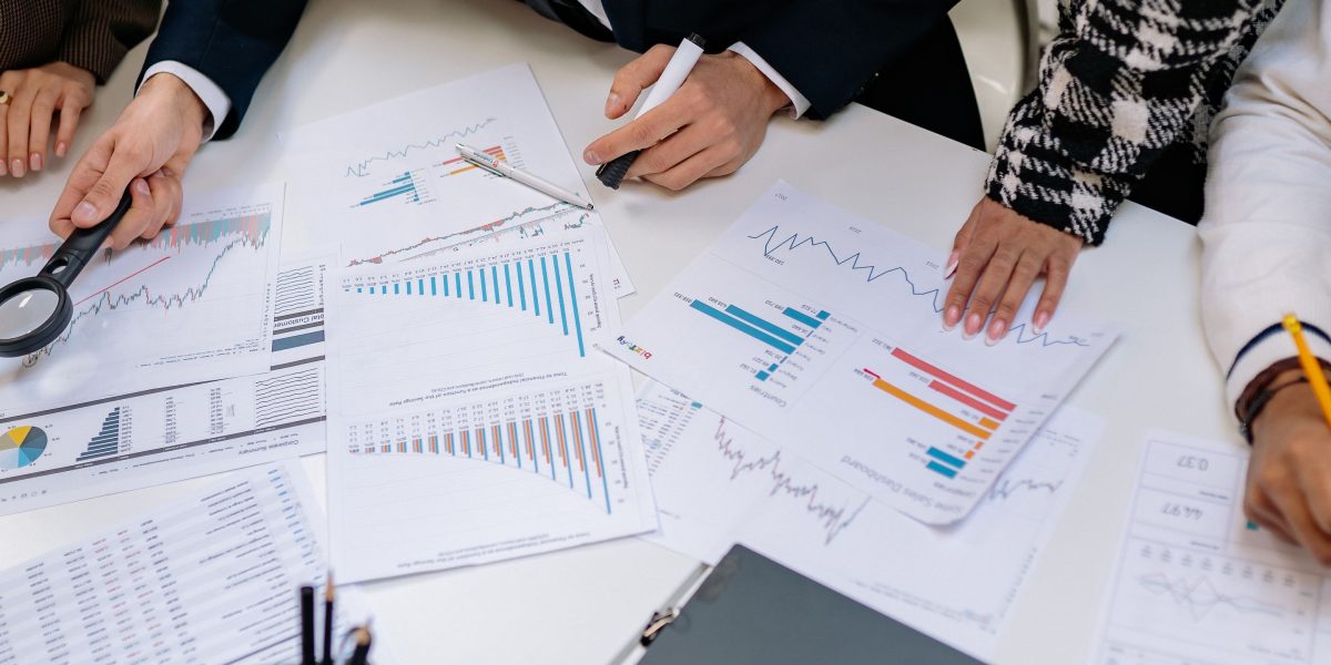 Professionals engaged in a discussion about financial plans or budgets, relevant to agency pricing.