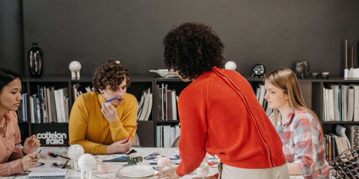 A team actively discussing and developing design concepts, reflecting the collaborative nature of newspaper design jobs.
