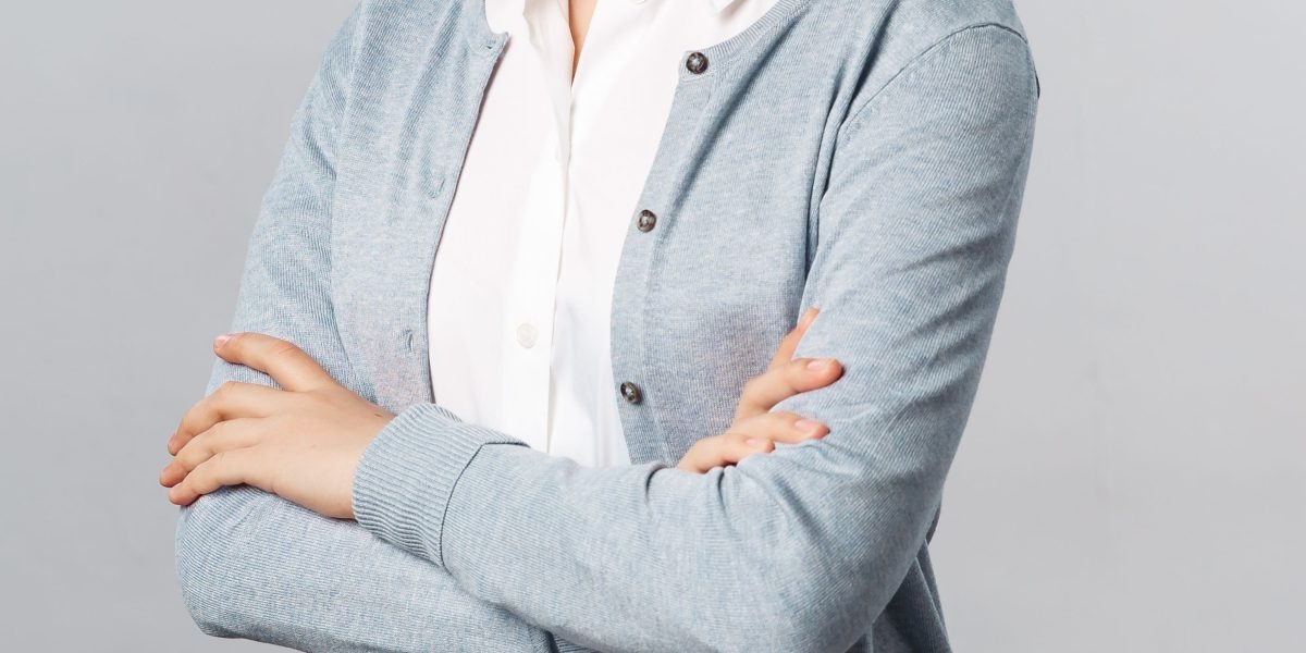 A person smiling confidently, representing career advancement and achievement in the design field.